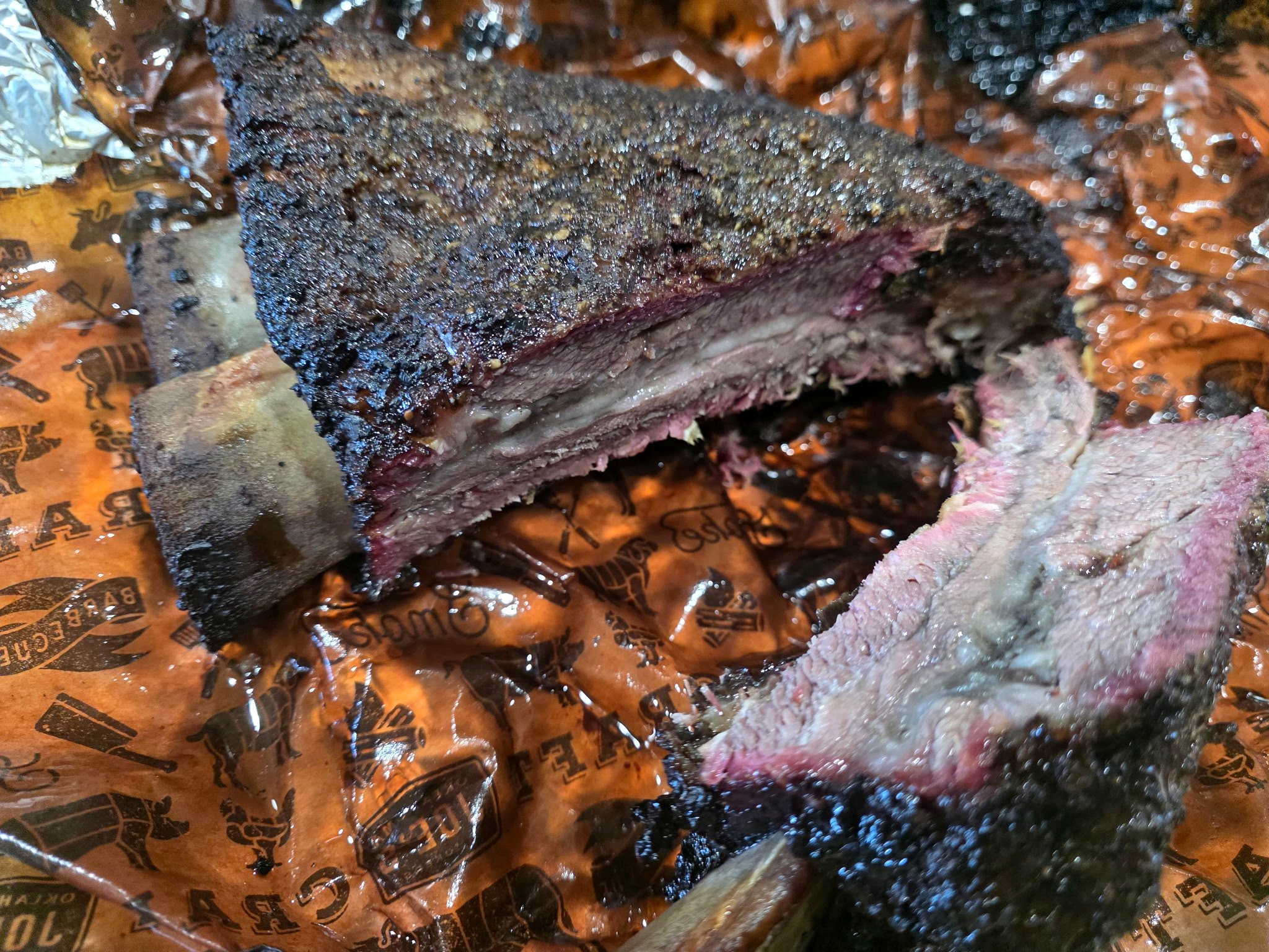 Slow-smoked beef rib sliced open to show the smoke ring and tender interior.